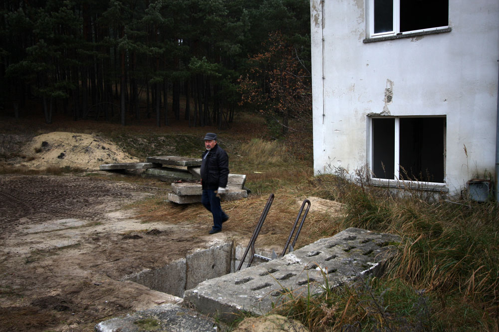 The owner of the bunker and site have lifted the heavy concrete plates and are welcoming us down the hole!